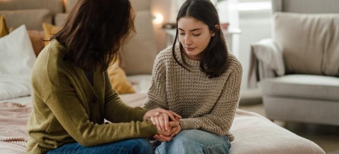 Jugendliche sitzt neben ihrer Mutter